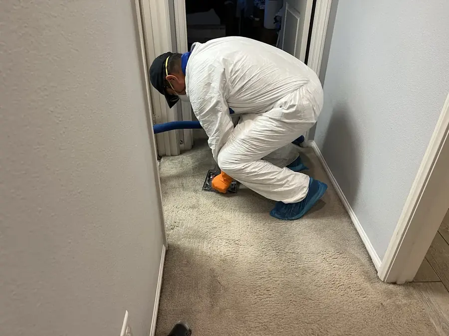 A technician checking a moisture reading in a San Marino, CA home